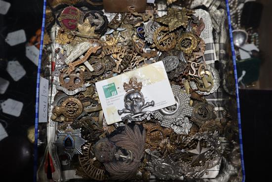 A large collection of military caps and tunic badges (some framed)